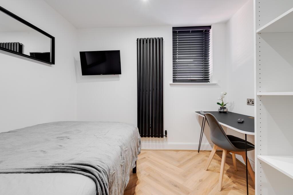 A modern, well-maintained bedroom featuring a c...