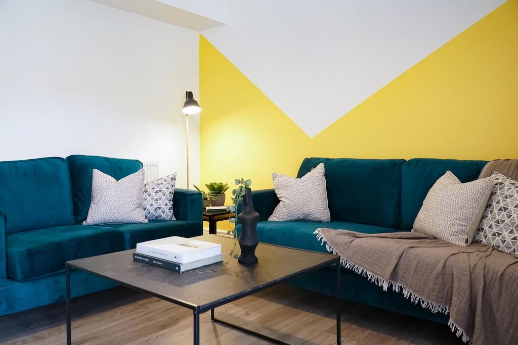A modern, well-lit living room featuring a styl...