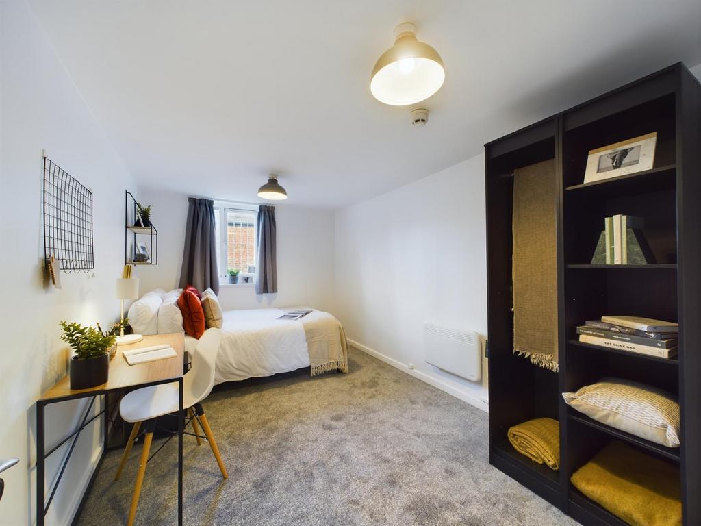 A spacious and inviting double bedroom featurin...