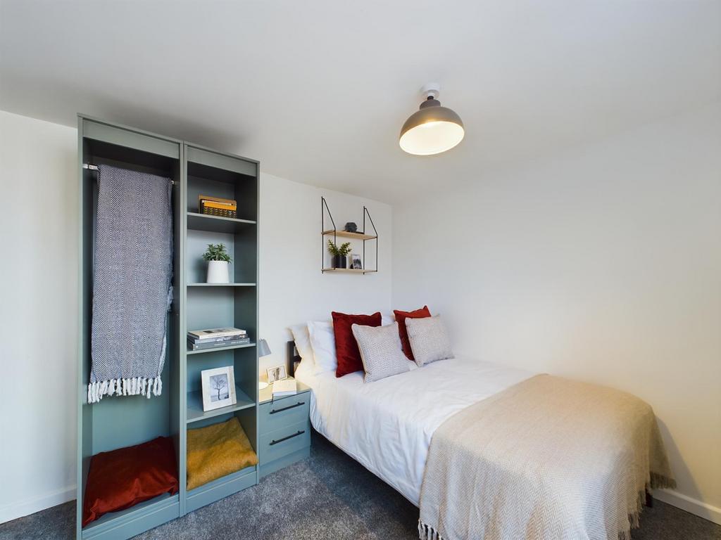 A bright and inviting double bedroom featuring ...