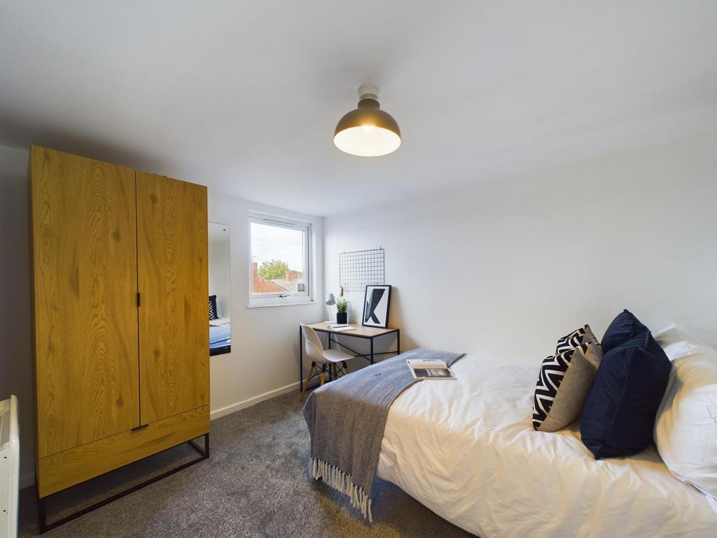 A bright and inviting double bedroom featuring ...