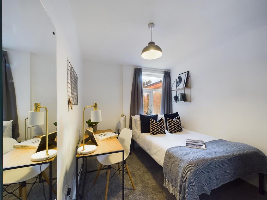 A bright and inviting double bedroom featuring ...