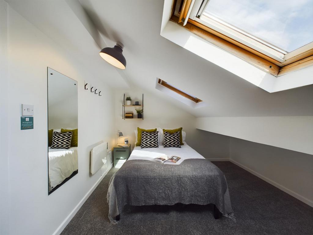 A bright and inviting double bedroom with moder...