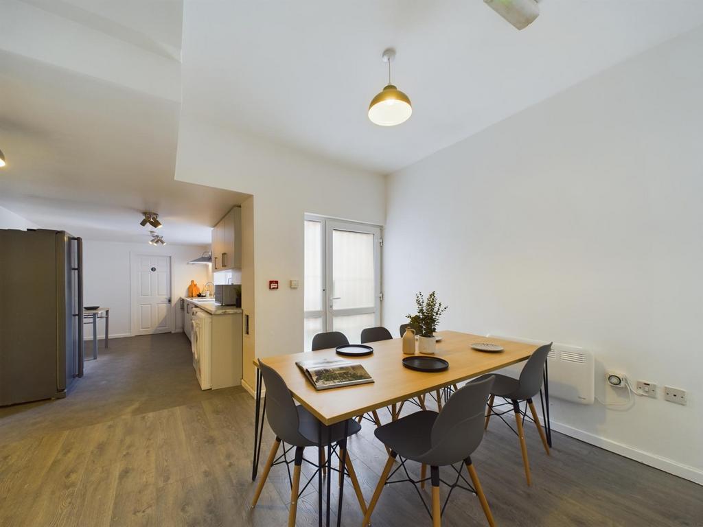 A spacious and bright kitchen area featuring a ...