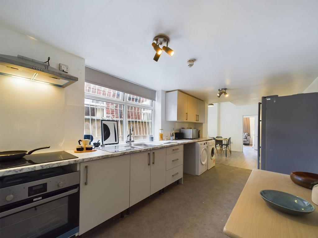 A spacious and modern kitchen with ample natura...