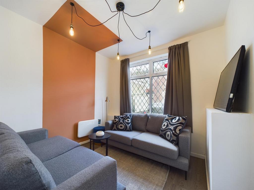 A bright and inviting living room featuring sty...
