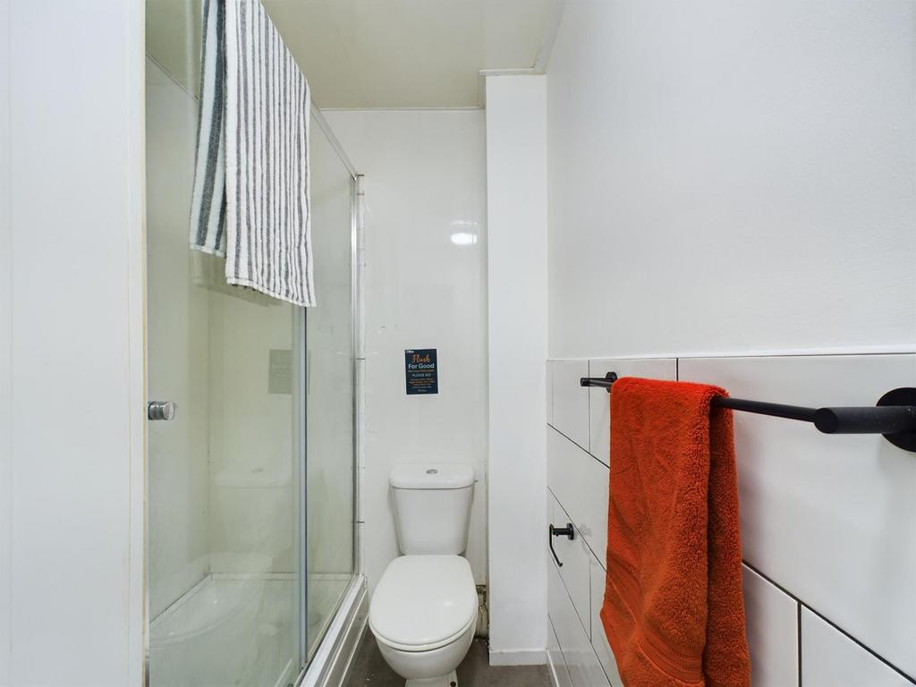 A modern and tidy bathroom featuring a spacious...