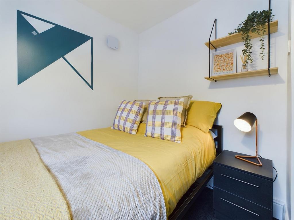 A bright and inviting double bedroom featuring ...