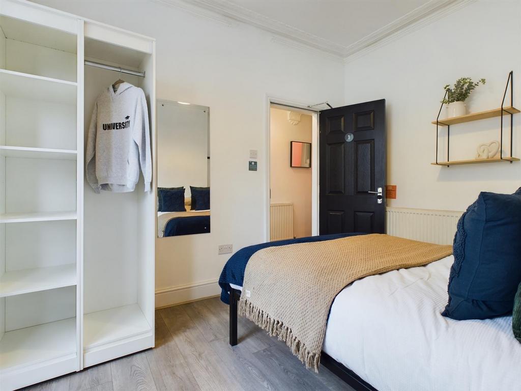 A bright and inviting double bedroom featuring ...