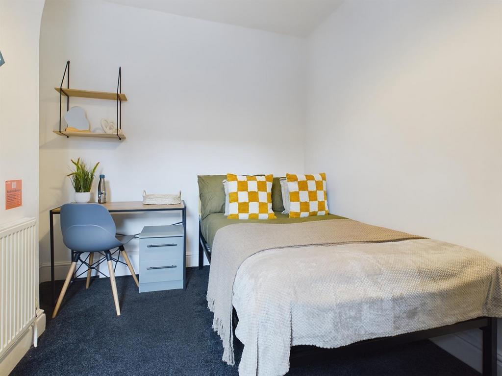 A bright and inviting double bedroom featuring ...
