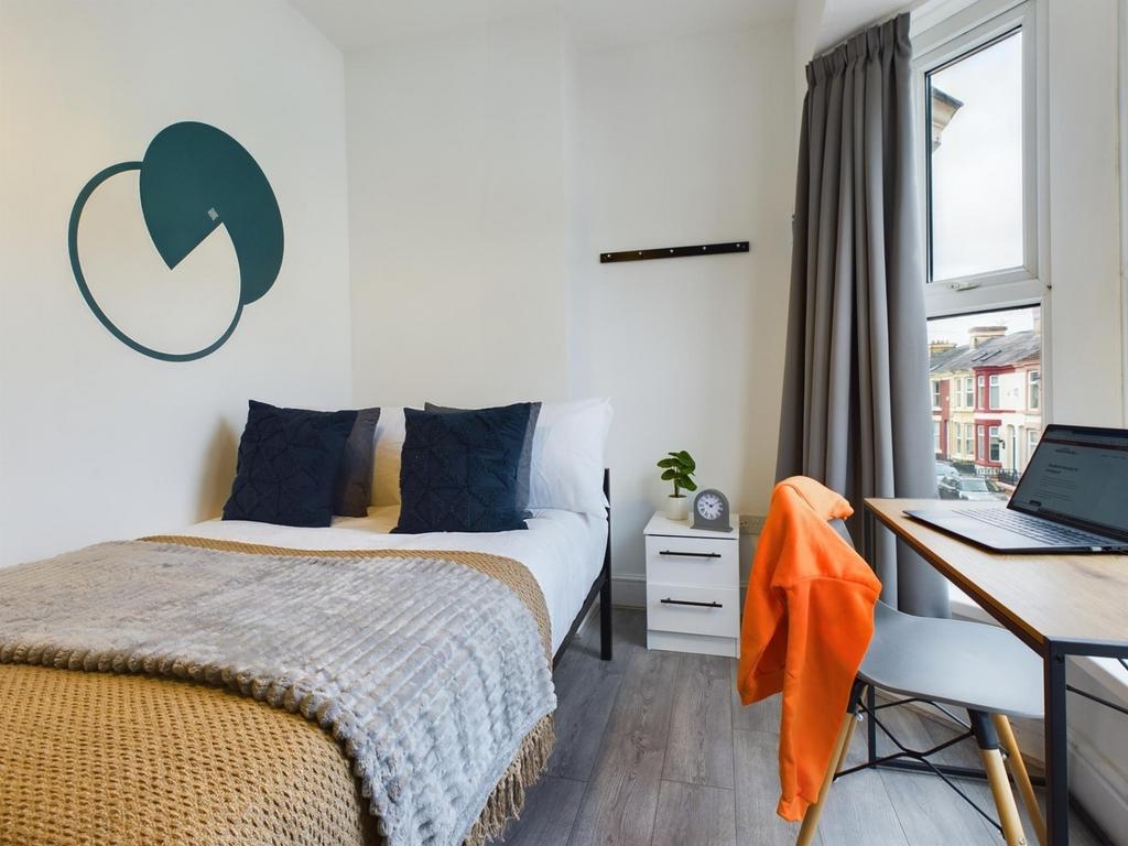 A bright and inviting double bedroom with moder...