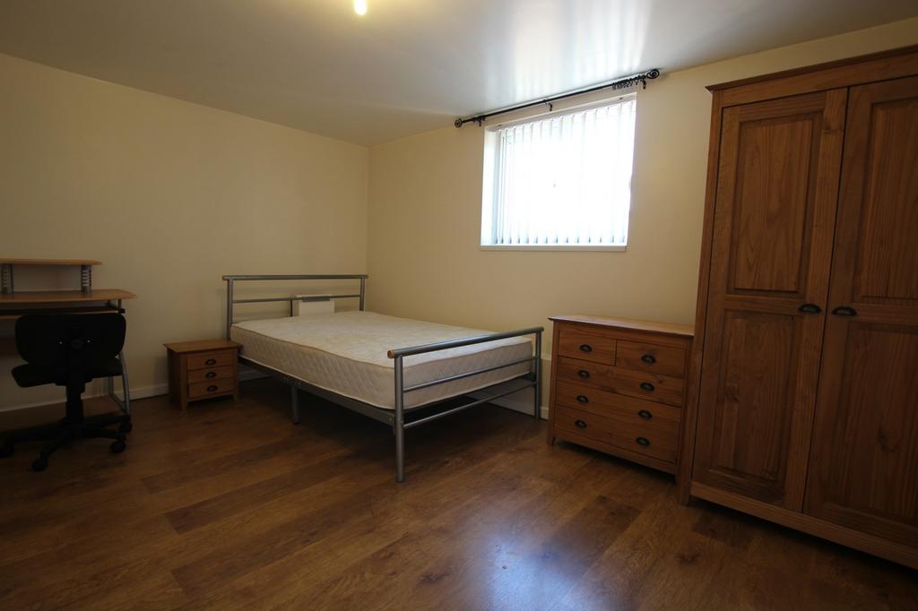A spacious and well-organized double bedroom wi...