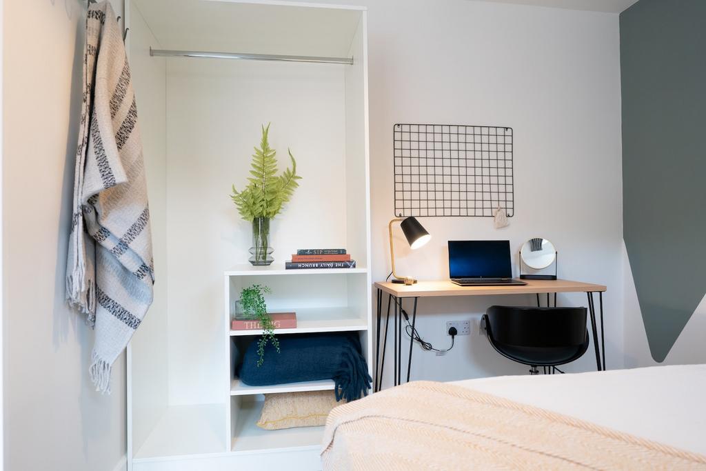 A bright and stylish double bedroom featuring a...