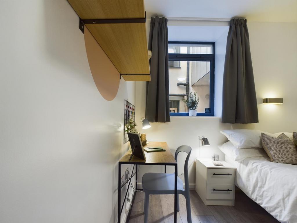 A bright and inviting double bedroom featuring ...