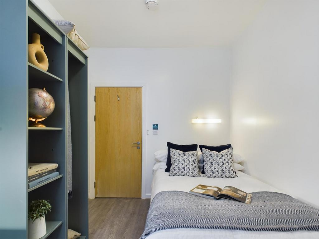 A bright and inviting double bedroom featuring ...