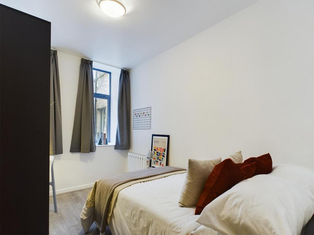A bright and inviting double bedroom featuring ...