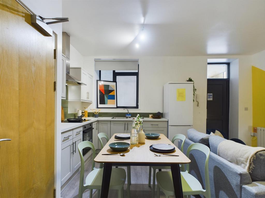 A bright and modern kitchen area with a welcomi...