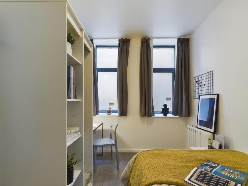 A bright and inviting double bedroom featuring ...