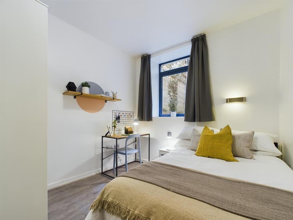 A bright and inviting double bedroom featuring ...