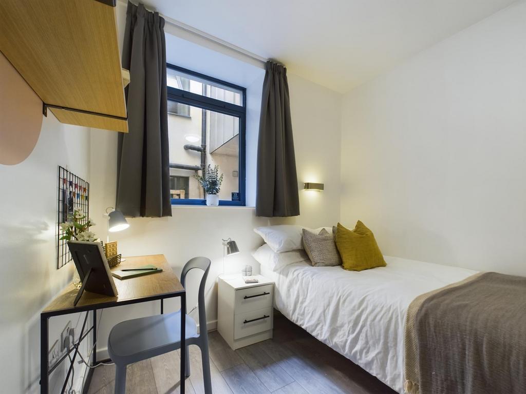 A bright and inviting double bedroom with moder...