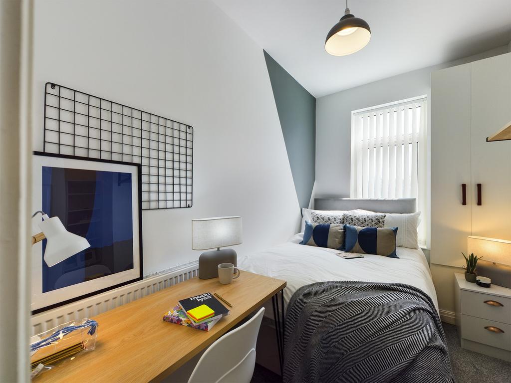 A stylish and well-lit double bedroom featuring...