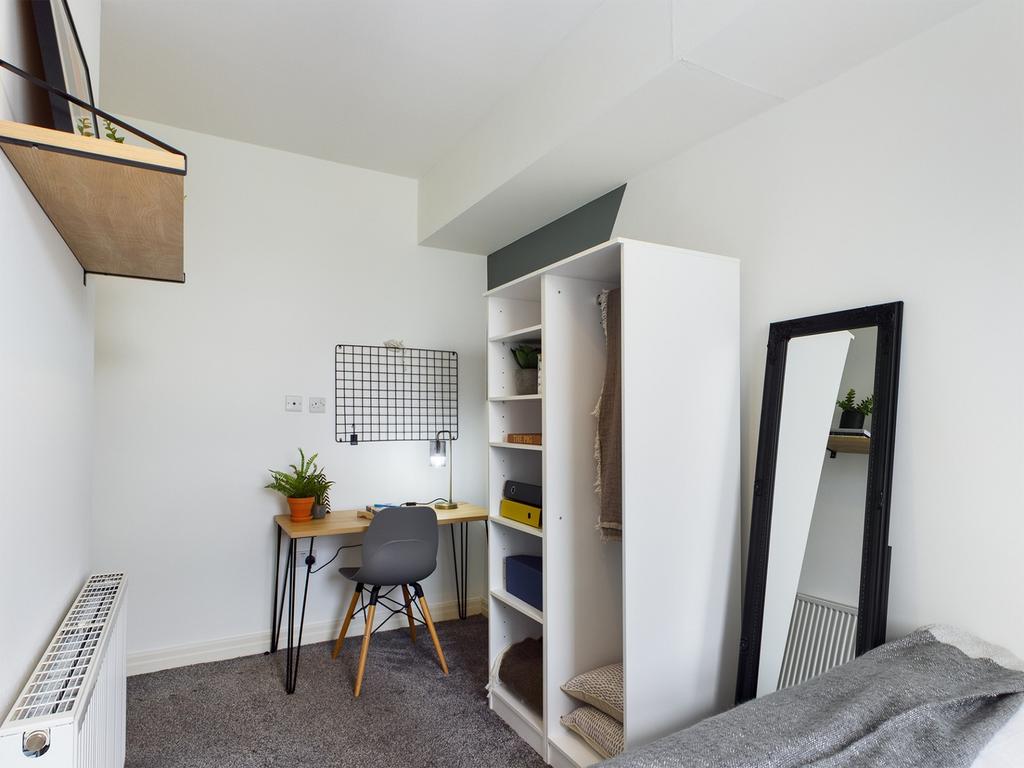 A cozy and inviting double bedroom featuring a ...
