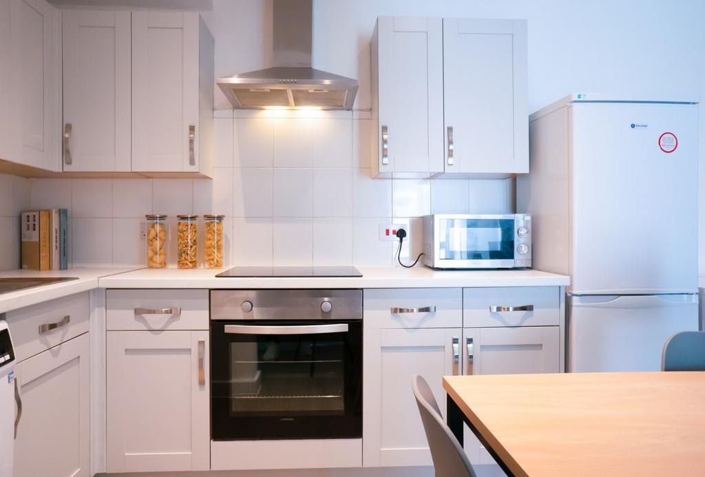 A modern and tidy kitchenette featuring ample s...