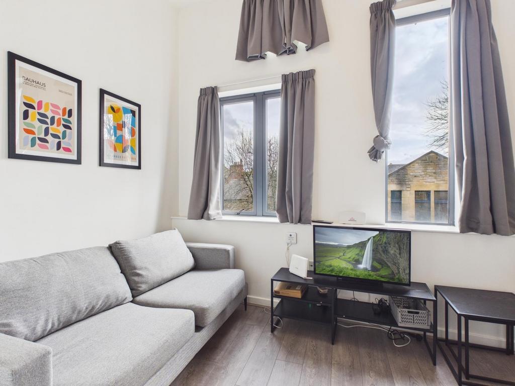 Bright, modern living room with a comfortable g...