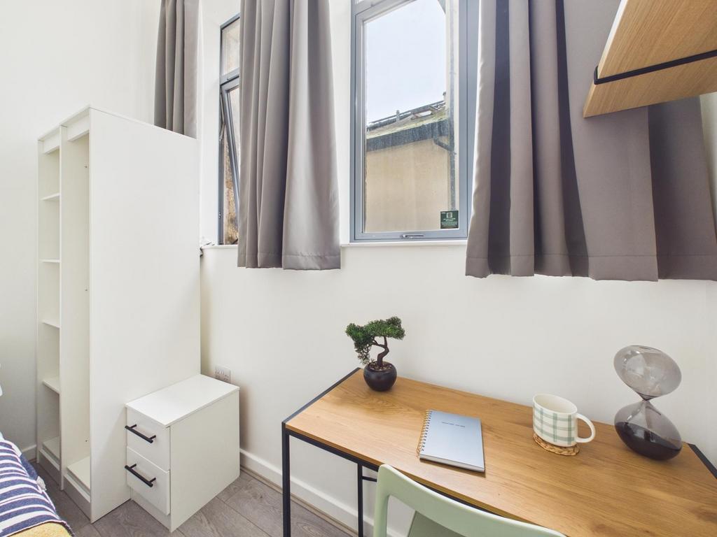 Bright, tidy single bedroom with a bedside stor...