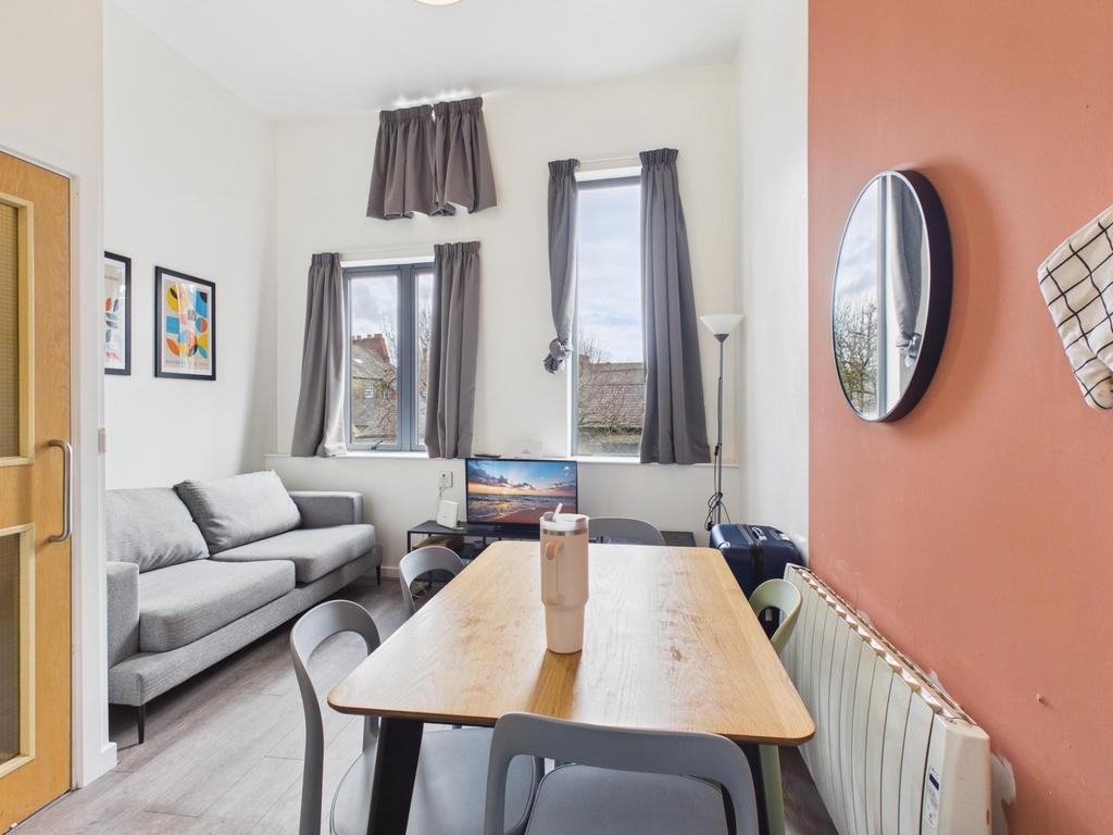 Bright, modern living room with a comfy grey so...