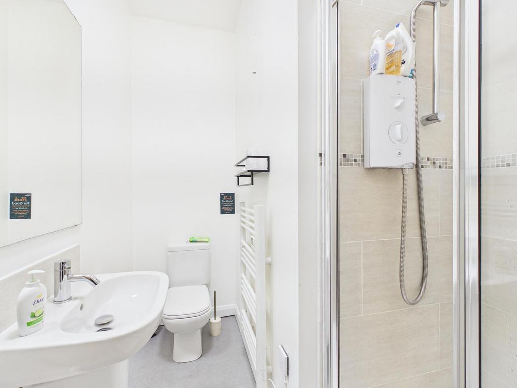 Bright, modern bathroom with a walk-in shower, ...