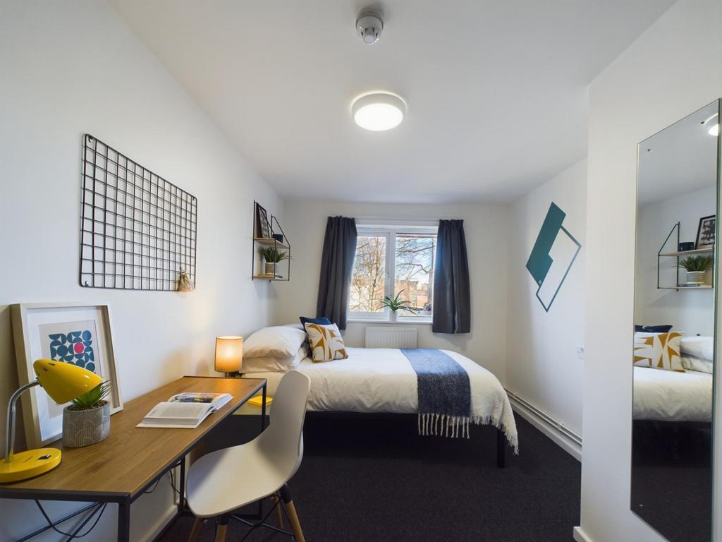 A bright and inviting double bedroom featuring ...