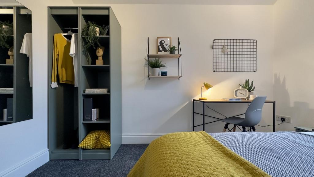 A bright and stylish double bedroom featuring m...