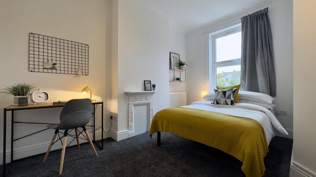 A bright and inviting double bedroom featuring ...