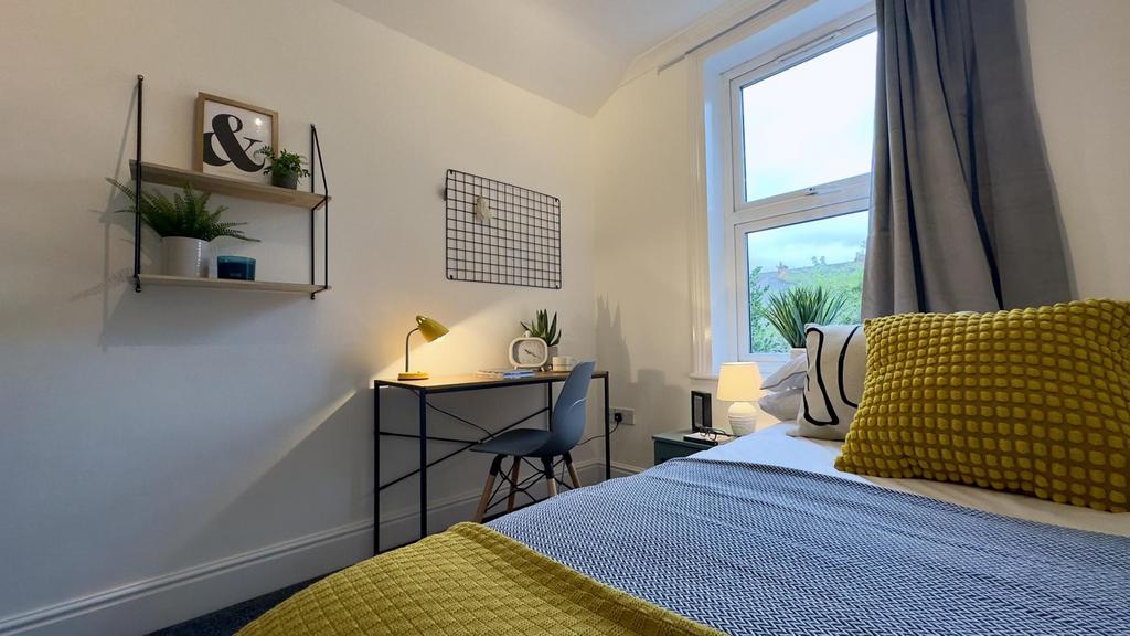 A bright and inviting double bedroom featuring ...