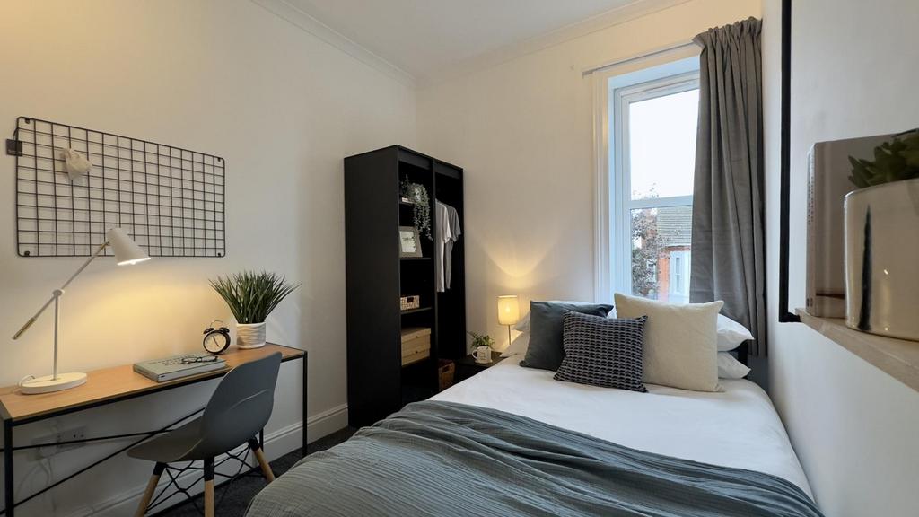 A bright and inviting double bedroom featuring ...
