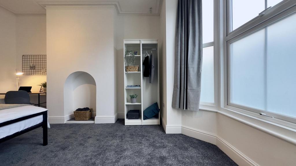 A spacious and bright double bedroom featuring ...