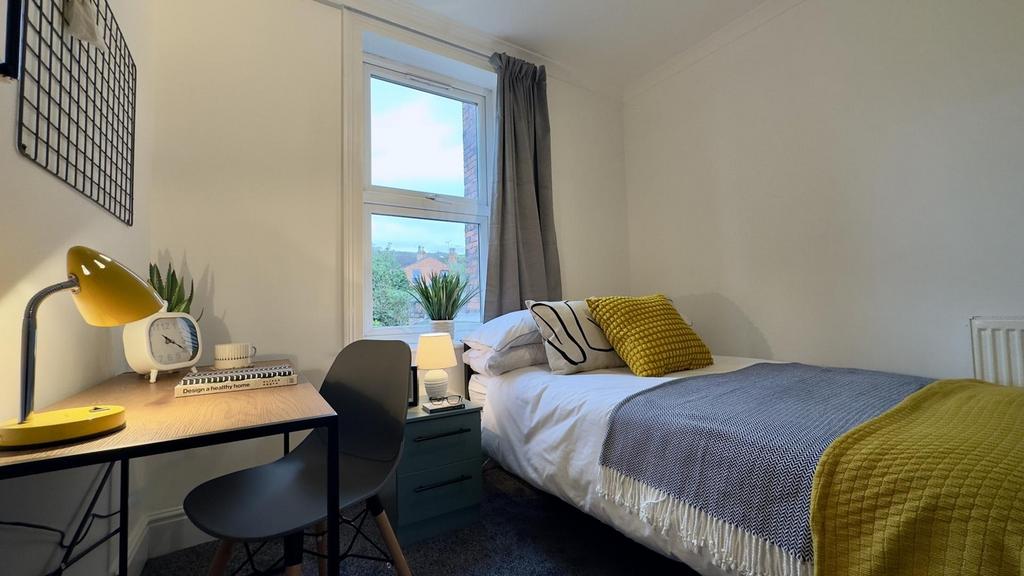 A bright and cozy double bedroom featuring a co...
