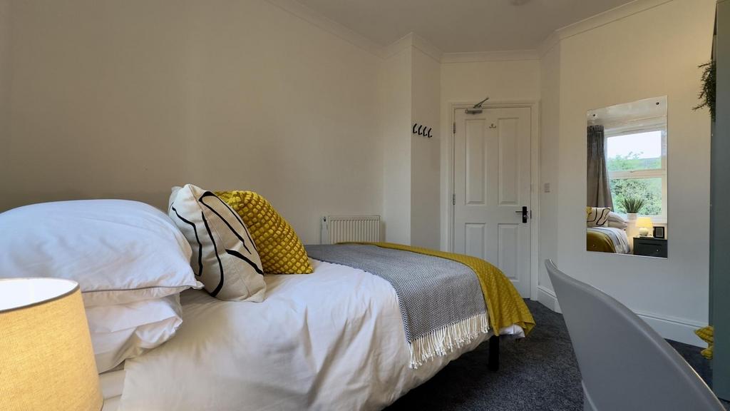 A bright and cozy double bedroom featuring styl...