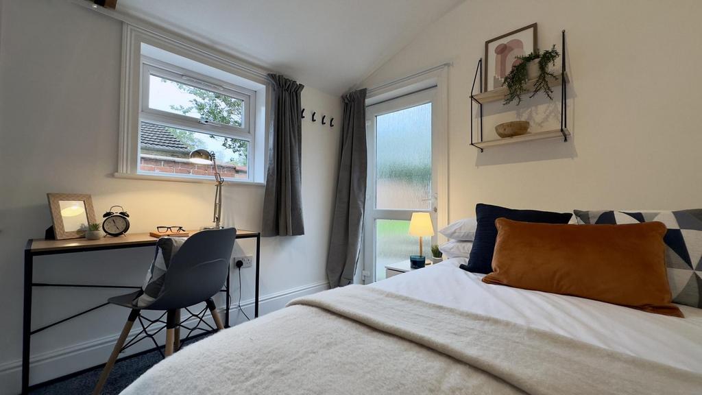 A bright and inviting double bedroom featuring ...