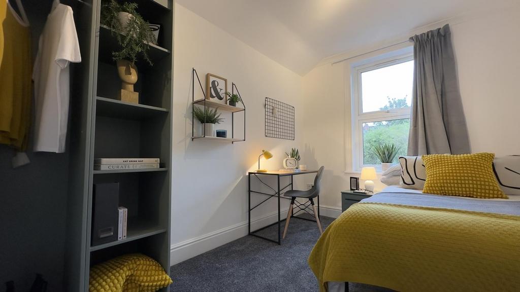 A bright and inviting double bedroom featuring ...