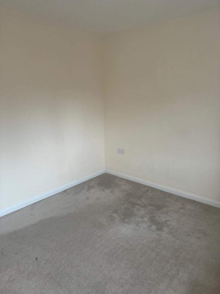 Empty bedroom corner with neutral painted walls...