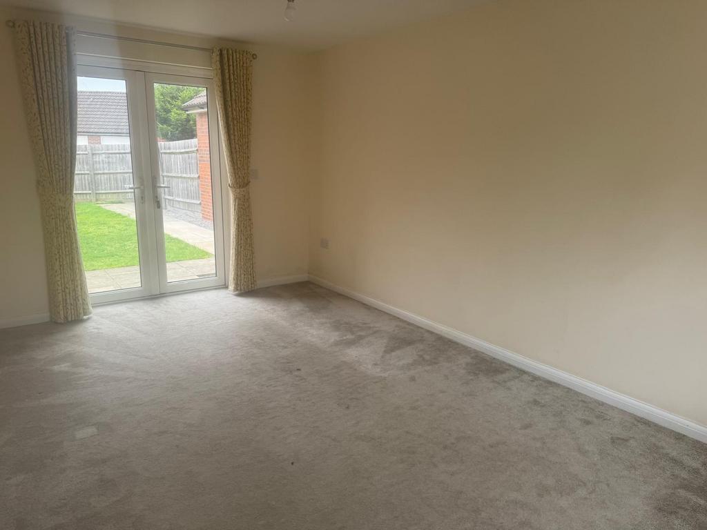 Bright living room with neutral décor, full-hei...