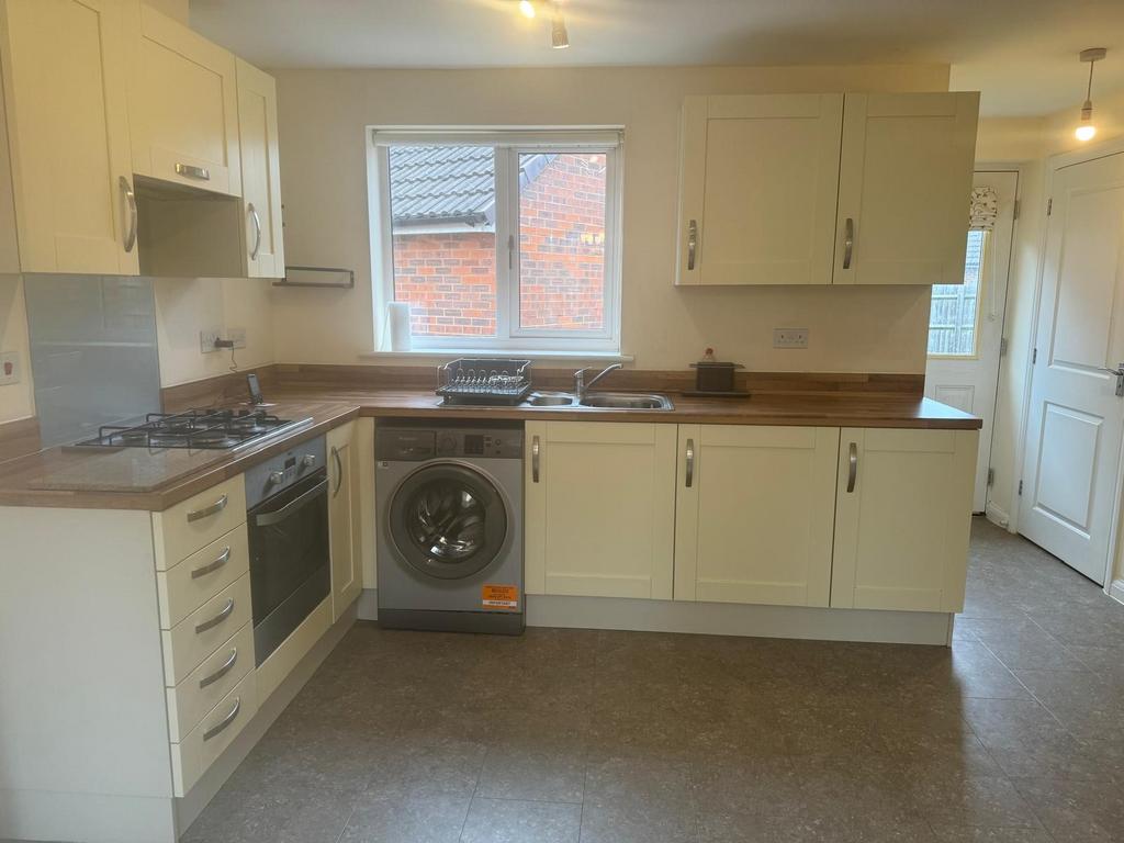 Bright, modern kitchen with fitted cabinets, wo...