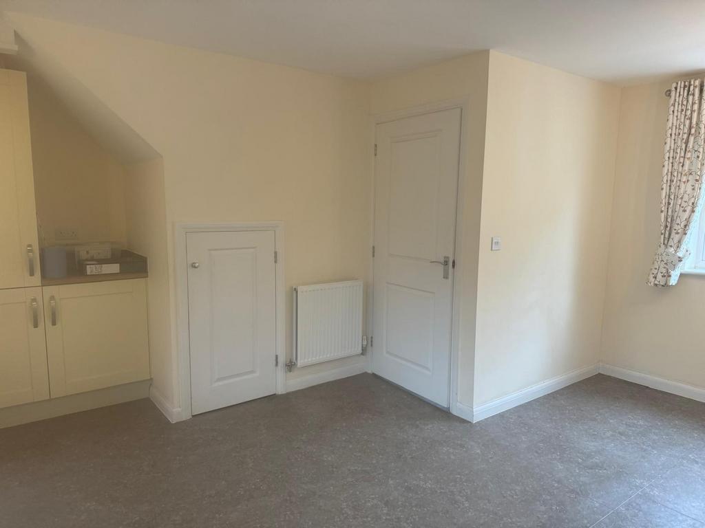 Bright neutral kitchen area with built-in cupbo...