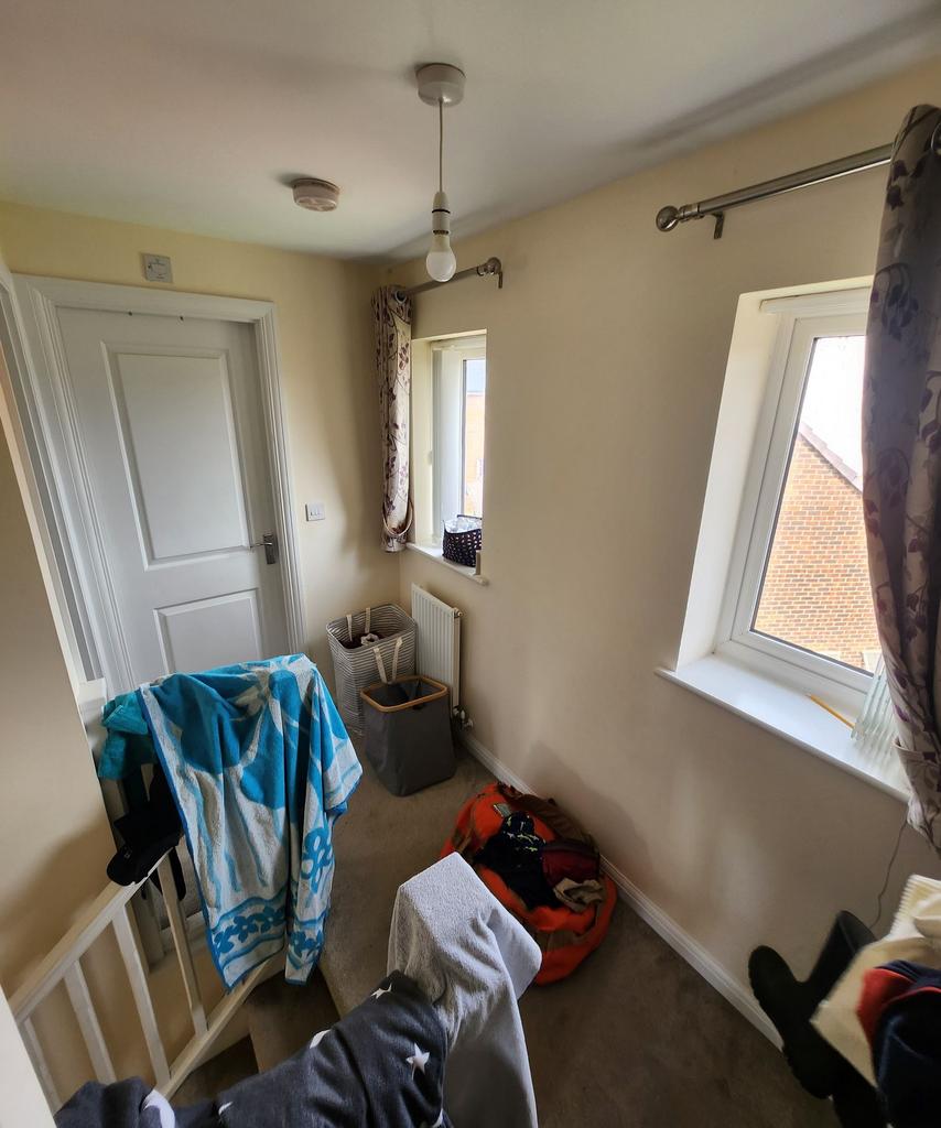 Bright upstairs landing with two windows, neutr...