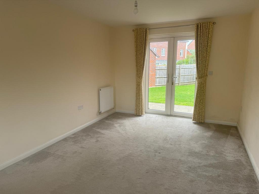 Bright ground-floor living room with full-heigh...