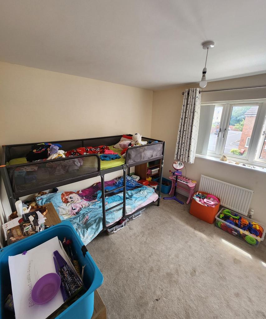 Bright, well-lit bedroom with a bunk bed and pl...