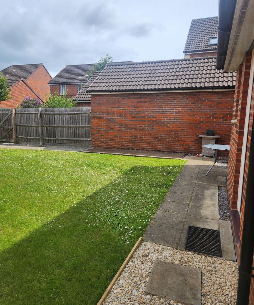 Well-maintained private rear garden with a neat...