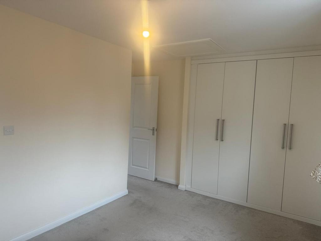 Bright, neutral double bedroom with built-in fu...